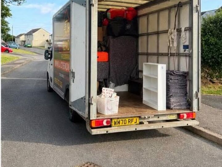 Rear doors open on a part-loaded AJC Removals van at a house move in Cornwall