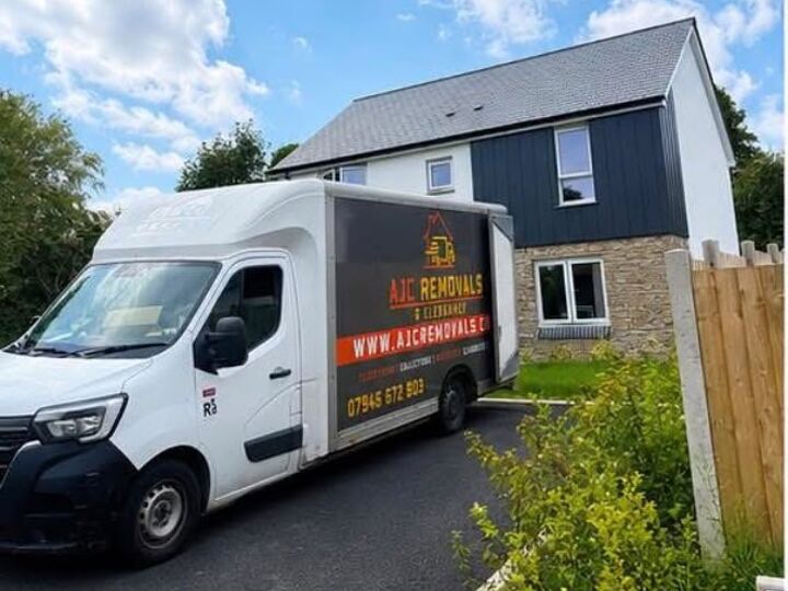 AJC Removals van parked on the driveway of a house in Cornwall on moving day